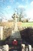 Rough hewn stone wheel cross in stone enclosure