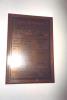 Brass plaque mounted on oak board