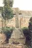 Rough hewn stone cross on rough hewn base