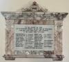 White marble inscription tablet in mottled marble frame, with names in black