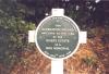 Circular plaque on cruciform base