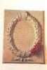 Stone tablet with raised wreath encircling inscribed names