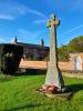 Rough hewn cross on tapering plinth