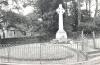 Rough hewn Celtic wheel cross on tapering plinth, with inscription on base