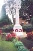Rough hewn Celtic wheel cross on tapering plinth, with inscription on base