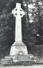 Rough hewn Celtic wheel cross on tapering plinth, with inscription on base