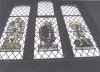 Stained glass window with figure slaying Dragon