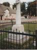 Rough cross on tapering plinth in small fenced area