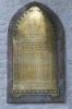 Brass plaque with bullet shape, inscription in black