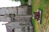 Pillar on plinth with gabled four sided top