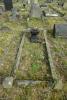 The vase and stand within the kerbed grave space