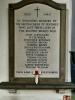White stone tablet with curved top and black lettered names
