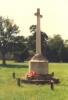 Tall Latin cross atop octagonal plinth
