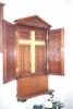 Wall mounted wooden triptych with doors and triangular pediment. Names within.