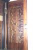 Wall mounted wooden triptych with doors and triangular pediment. Names within.