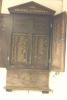 Wall mounted wooden triptych with doors and triangular pediment. Names within.