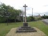 North-west face of the Barnack Memorial Cross (with flagpole and village sign in background)
