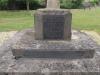 North-west face of plinth and top-step, with WW1 dedicatory plaque and WW2 plaque. (The original WW2 inscription, carved into the upper-surface of the top step, is also visible)