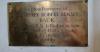 A brass plaque commemoration the death of the subject and the circumstances.
