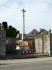 Tall cross on stepped base near road