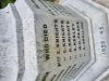 An octagonal marble memorials with a Latin cross, plinth, base and Sword of Sacrifice. Commemorating those who died in WW1 and WW2. Names K-S