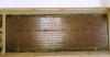Rectangular, framed metal plaque with lettering in relief