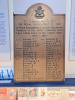 Nowy headed, rectangular brass plaque with inscription