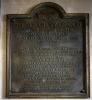 Cast metal plaque with raised lettering.
