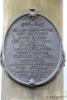 Oval metal plaque with dedication in relief