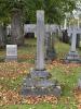 Three step stone gravestone topped with a cross