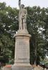 Cast figure atop circular plinth