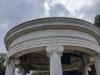 Open Ionic rotunda with a low dome supported by six columns. In the centre, a figure with lance in his left hand and his right arm extended
