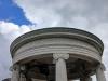 Open Ionic rotunda with a low dome supported by six columns. In the centre, a figure with lance in his left hand and his right arm extended