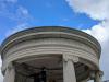 Open Ionic rotunda with a low dome supported by six columns. In the centre, a figure with lance in his left hand and his right arm extended