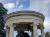 Open Ionic rotunda with a low dome supported by six columns. In the centre, a figure with lance in his left hand and his right arm extended
