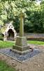 Cross on tapering plinth with inscription