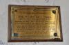Wall mounted brass plaque on wooden board