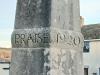 The word PRAISE and the date 1920 carved into the middle part of the obelisk