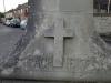 A carved detail on the obelisk showing a cross and the word SACRIFICE
