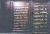 Wooden panel with inscription in gold painted lettering