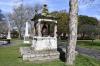 Pagoda shaped monument with bell and inscription