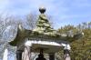 Pagoda shaped monument with bell and inscription
