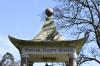 Pagoda shaped monument with bell and inscription