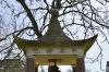 Pagoda shaped monument with bell and inscription