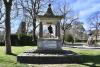 Pagoda shaped monument with bell and inscription