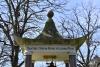 Pagoda shaped monument with bell and inscription