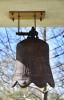 Pagoda shaped monument with bell and inscription