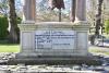 Pagoda shaped monument with bell and inscription