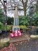Celtic cross on tapering plinth with plaque attached to front
