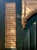 close view of upper dedicatory panel to left of door